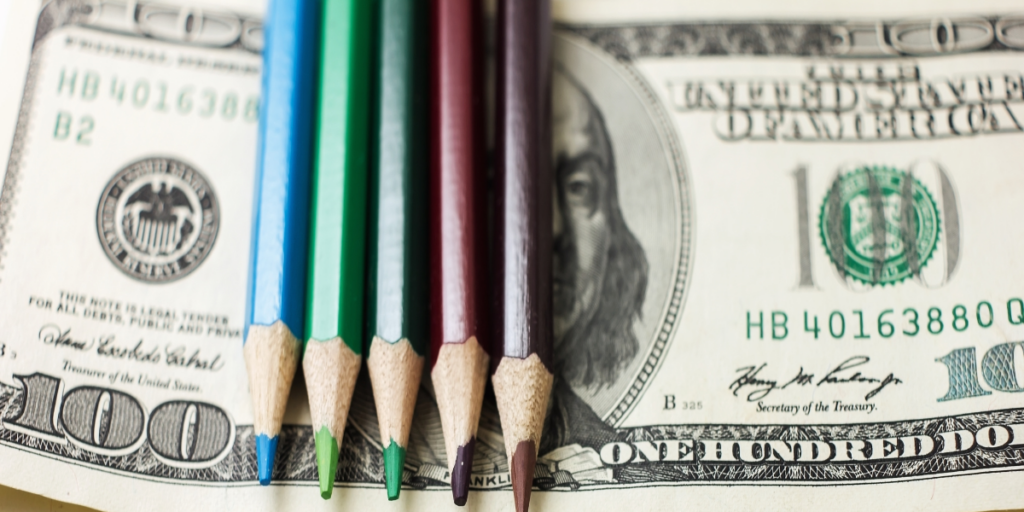 Pencils on top of cash
