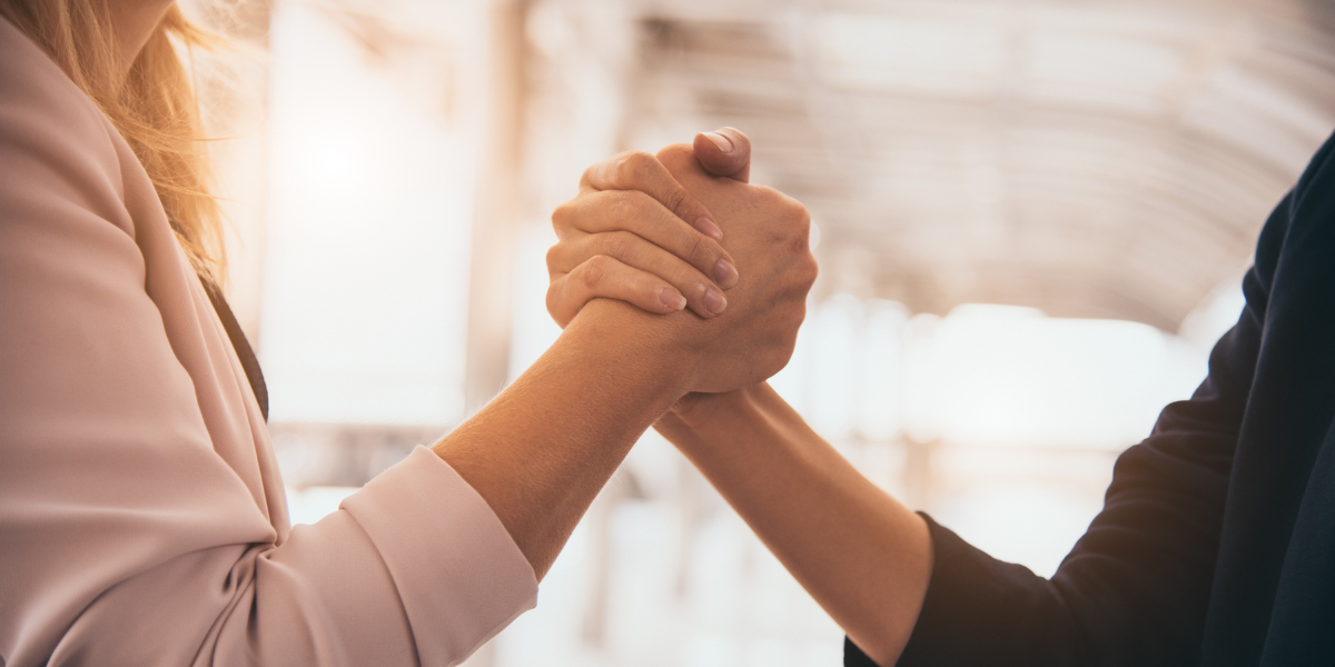 Grant manager shaking hands with grant management partner