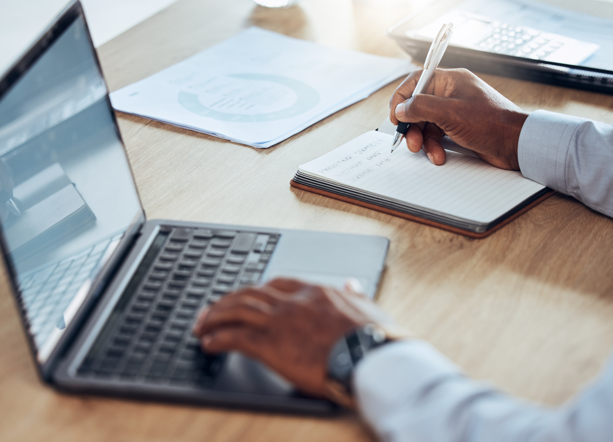 Grant Manager using computer and note pad to determine qualified State and Local Fiscal Recovery Funds obligations